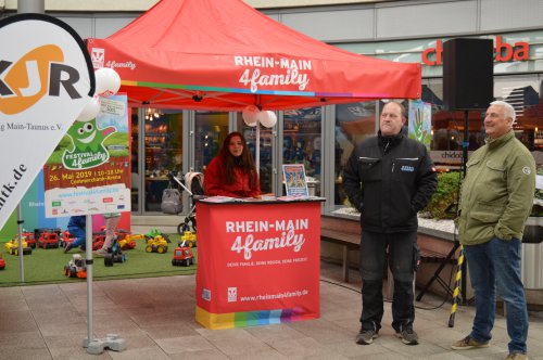 Roter Aktionsstand „Rhein-Main 4family" mit einer Frau und zwei Männern im Einkaufszentrum